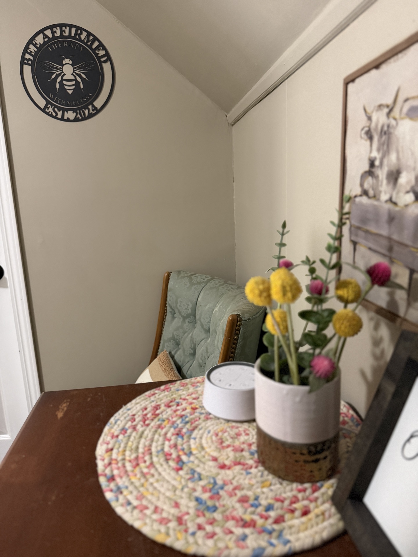 Therapy room with Bee Affirmed logo and comfortable seating
